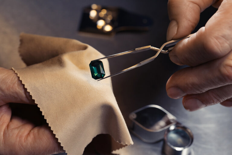 Professional jeweler working with gemstone, closeup view